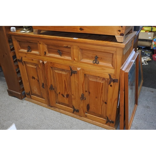 609 - A pine sideboard with ironwork hinges and handles.  Approx  90x124x49cm.