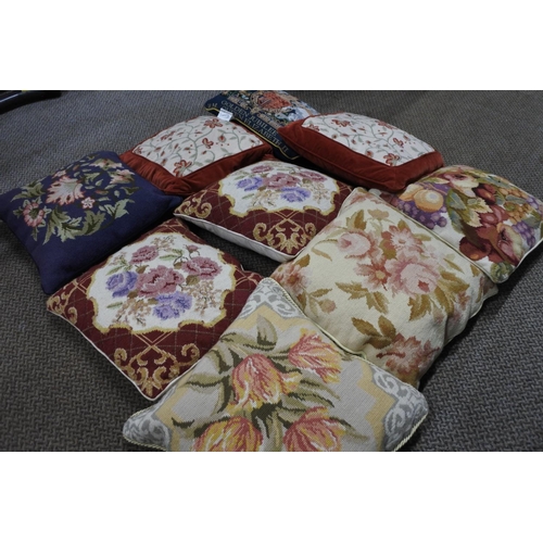 619 - Nine assorted cushions with floral detail.