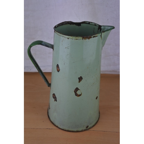 621 - A vintage green enamel water jug.  Approx  27cm.