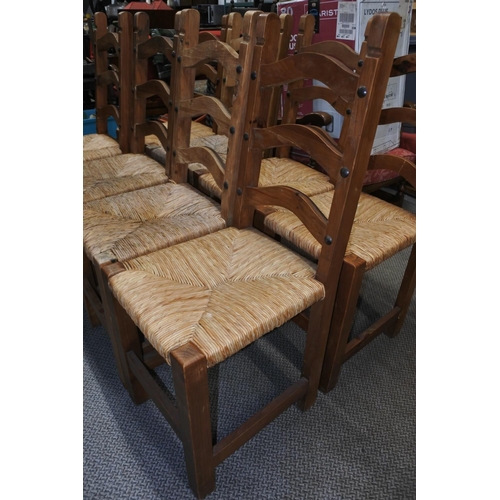 624 - A set of six pine framed dining room chairs with rattan upholstered seats and ironwork detail,