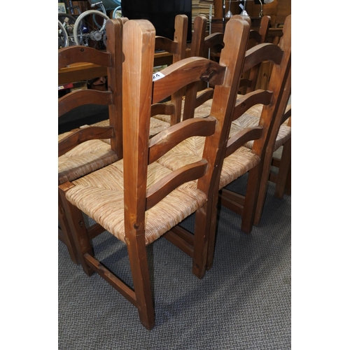 624 - A set of six pine framed dining room chairs with rattan upholstered seats and ironwork detail,