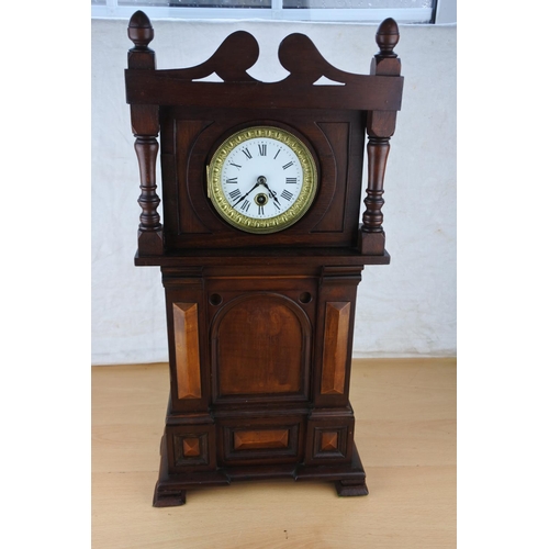 633 - An unusual mahogany cased wall clock with ceramic clock face. Approx  54cm.