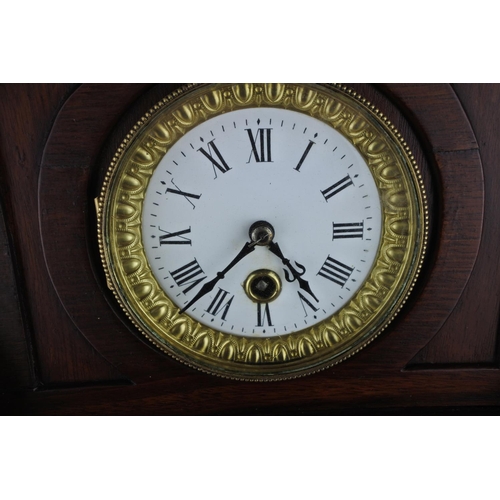 633 - An unusual mahogany cased wall clock with ceramic clock face. Approx  54cm.