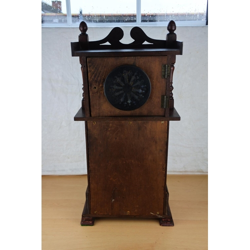 633 - An unusual mahogany cased wall clock with ceramic clock face. Approx  54cm.