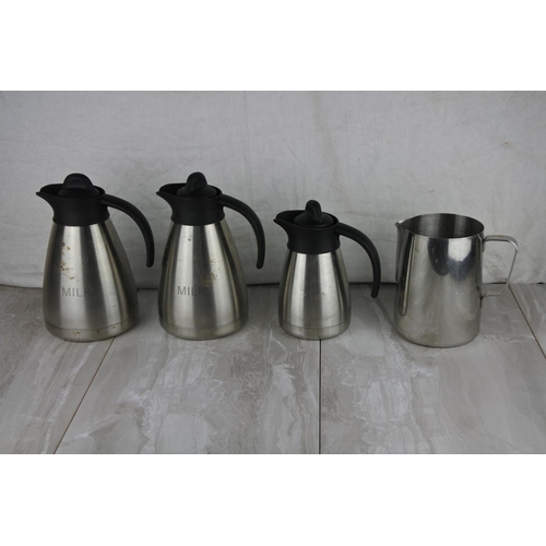 675 - Two stainless steel 'Milk' jugs and two others.