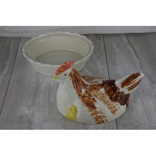 695 - A ceramic hen on nest.
