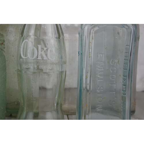 716 - A lot of antique and vintage glass bottles to include William Corry & Co, Coca Cola and more.