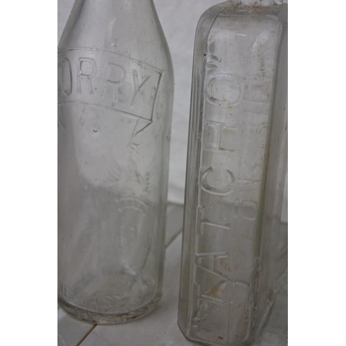 716 - A lot of antique and vintage glass bottles to include William Corry & Co, Coca Cola and more.