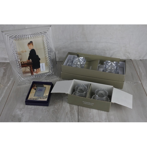 717 - Two boxed Tipperary Crystal candlesticks, a Tyrone Crystal photograph frame, a boxed Special Memorie... 