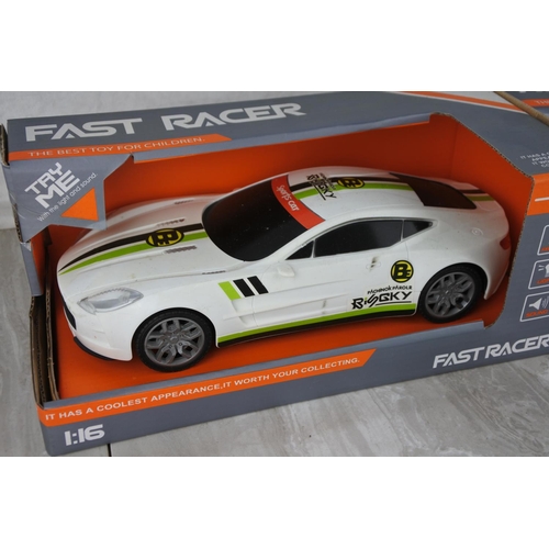 723 - Two boxed Fast Racer toy cars scale 1:16.