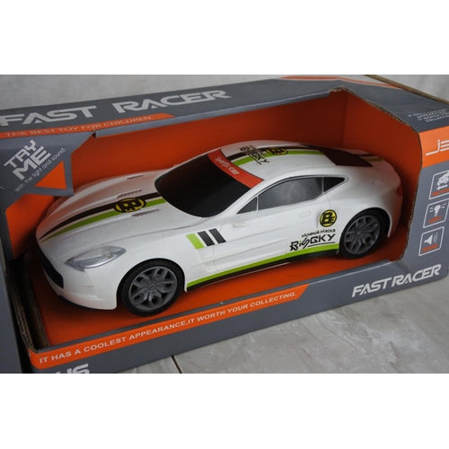 734 - Two boxed Fast Racer toy cars scale 1:16.