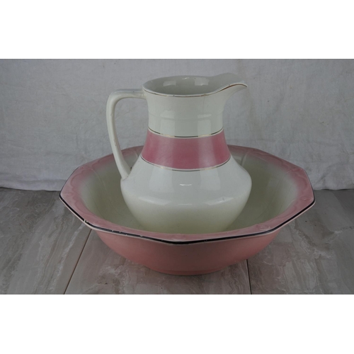 737 - An antique pottery jug and basin set.