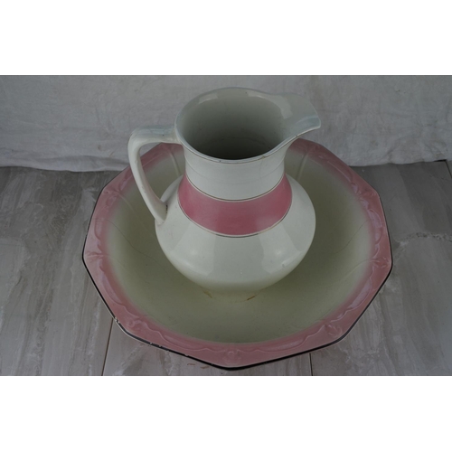 737 - An antique pottery jug and basin set.