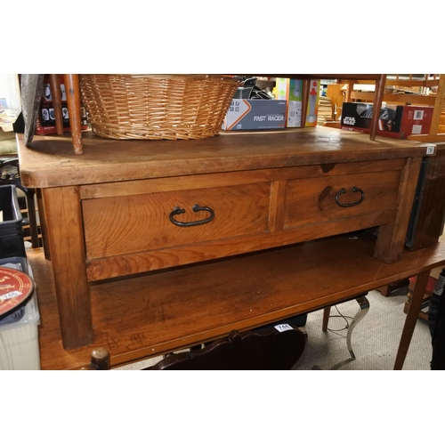 750 - A chunky pine coffee table with ironwork handles and drawers either side.