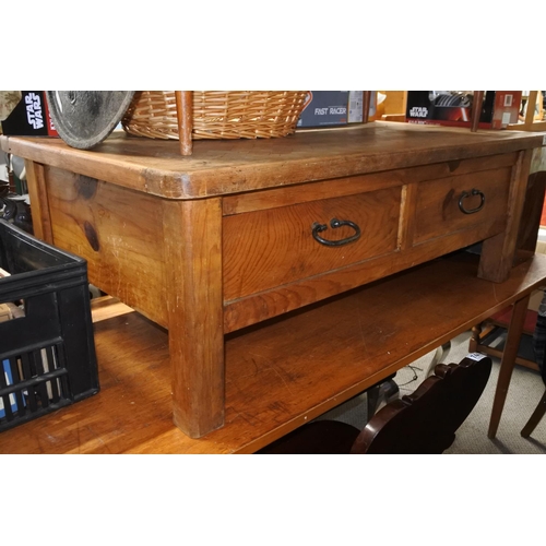 750 - A chunky pine coffee table with ironwork handles and drawers either side.