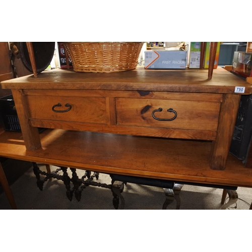 750 - A chunky pine coffee table with ironwork handles and drawers either side.