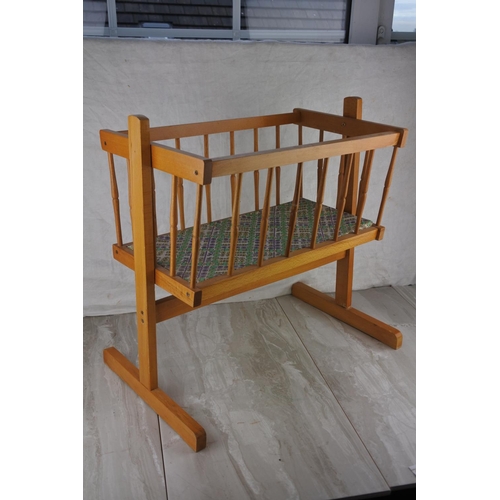 759 - A doll's wooden cradle. approx 46x48cm.