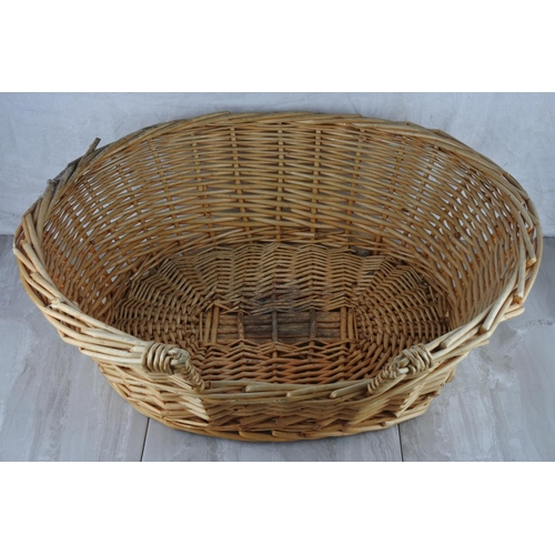 766 - A wicker dog basket. approx 20x60cm.