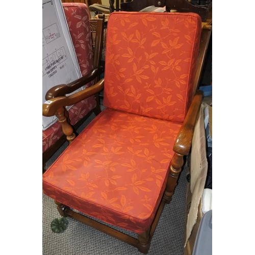 776 - An upholstered armchair with loose cushions.