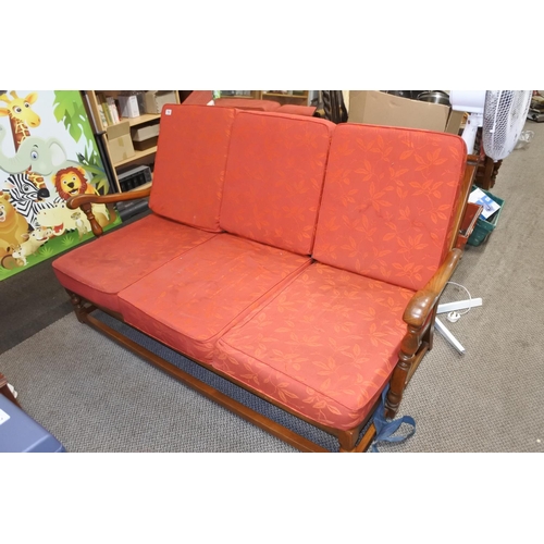 790 - A wooden framed Ercol upholstered three seater cottage style settee with removable cushions.