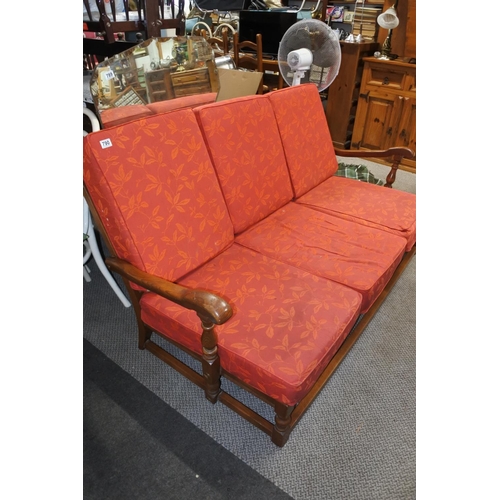 790 - A wooden framed Ercol upholstered three seater cottage style settee with removable cushions.