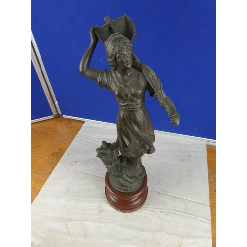 849 - An antique spelter figure on a wooden plinth.