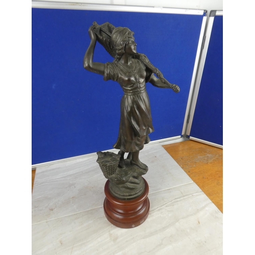 849 - An antique spelter figure on a wooden plinth.