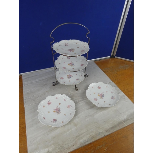 806 - A vintage three tier silver plated cake stand and two extra plates.