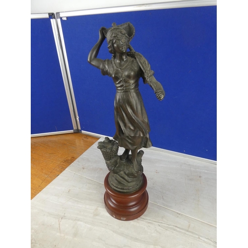 849 - An antique spelter figure on a wooden plinth.