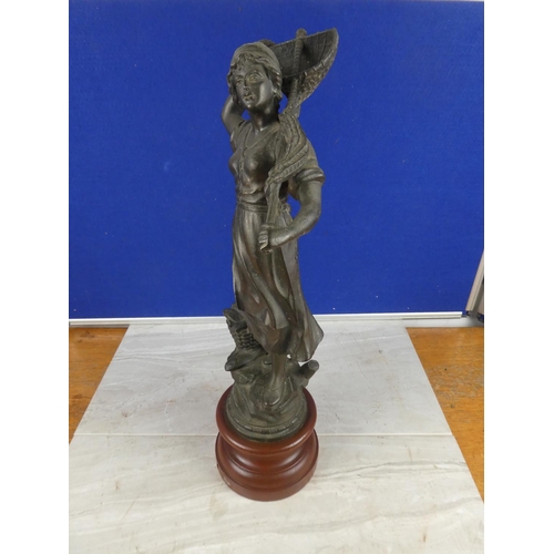 849 - An antique spelter figure on a wooden plinth.