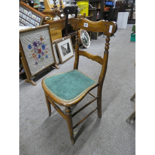 881 - An oak carved back bedroom chair.