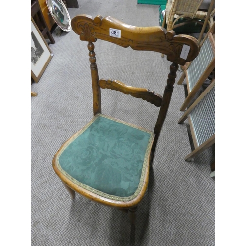 881 - An oak carved back bedroom chair.