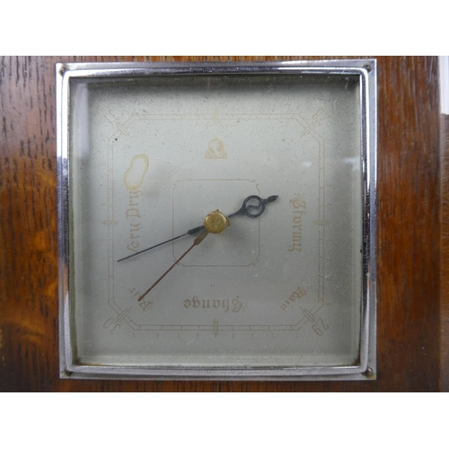 917 - A vintage oak cased barometer.