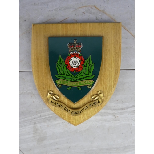 927 - A wooden shield wall plaque 'Intelligence Corps'. 18cm.