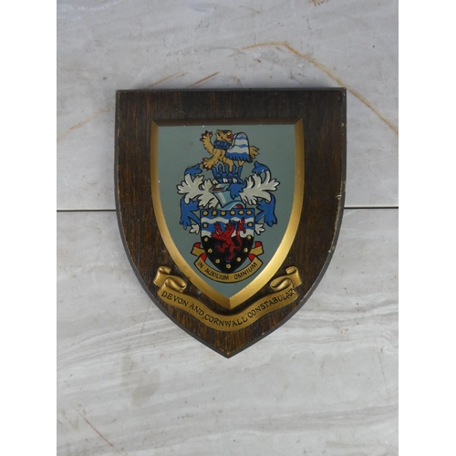 929 - A wooden shield wall plaque 'Devon and Cornwall Constabulary'. 18cm.