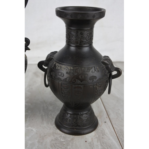 1015 - Two antique metal vases with oriental etched design. approx 20cm.