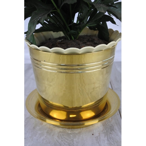 1021 - An artificial plant in a brass plant pot.