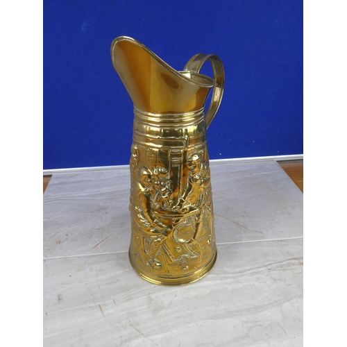 1057 - A vintage brass jug with a tavern scene. approx 35cm.