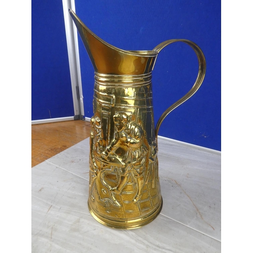 1057 - A vintage brass jug with a tavern scene. approx 35cm.