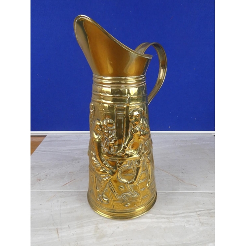 1057 - A vintage brass jug with a tavern scene. approx 35cm.