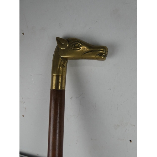 1061 - A brass horse head walking stick and another.