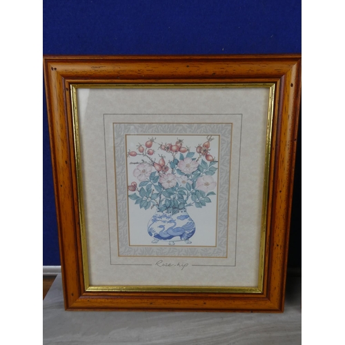 1067 - A pair of framed prints of flowers.