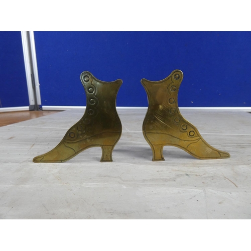 1110 - A pair of brass boot ornaments.