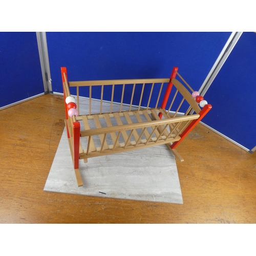 1116 - A wooden doll's cot. approx 36x53cm.