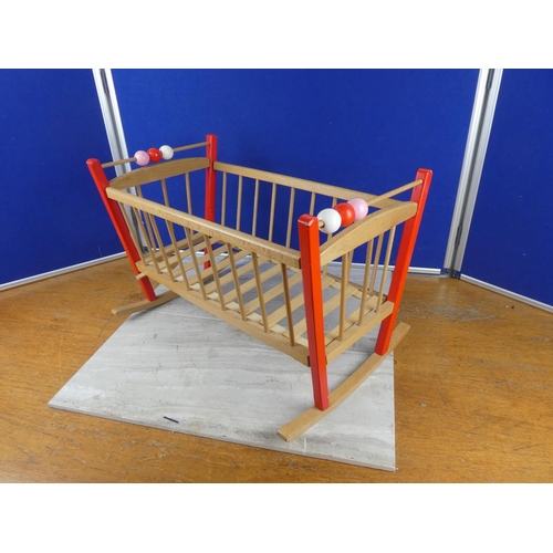 1116 - A wooden doll's cot. approx 36x53cm.