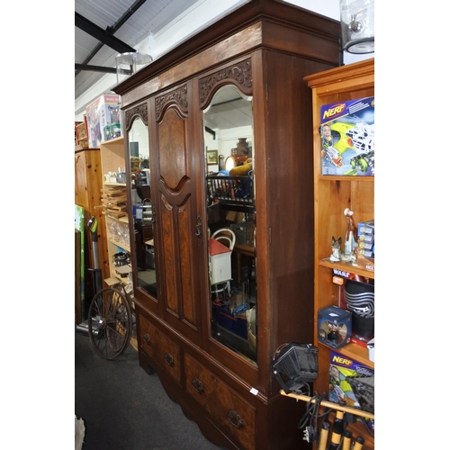 1152 - A stunning antique mahogany two door wardrobe with mirror doors. approx 215x150x48cm.