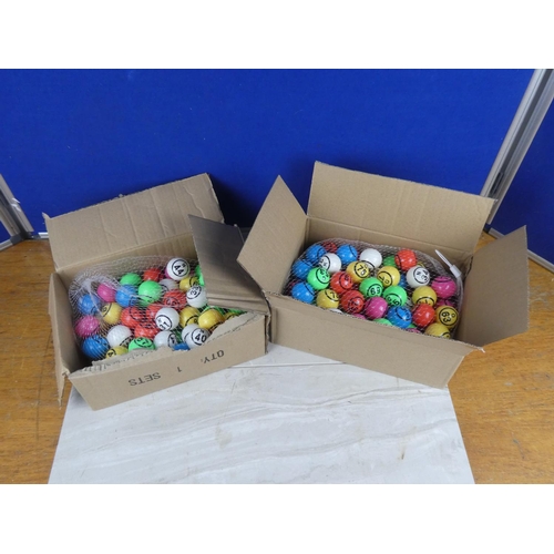 822 - Two boxes of bingo balls.