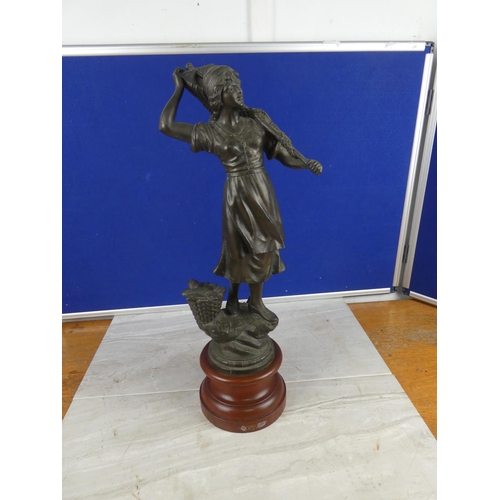 849 - An antique spelter figure on a wooden plinth.