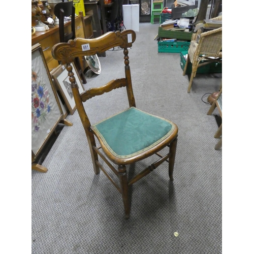 881 - An oak carved back bedroom chair.