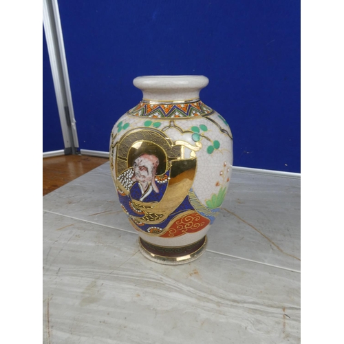 894 - An oriental style vase with hand painted detail.